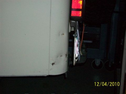 1986 Jeep Wagoneer - Close-up of a vehicle's rear corner with a red taillight and chrome bumper detail.