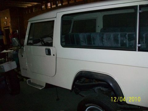 1986 Jeep Wagoneer - This Jeep CJ-8 Scrambler is shown from the side, parked indoors with the date 12/04/2010 visible.