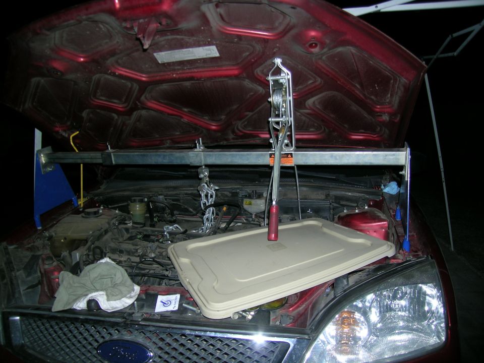 1995 Ford Probe engine bay with hoist and cover