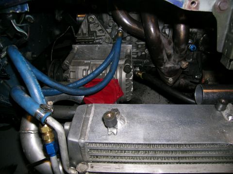 1995 Ford Probe - Close-up view of a modified engine bay, showing an intercooler and turbocharger components.