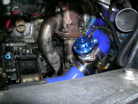 1995 Ford Probe - Aftermarket turbocharger and blow-off valve assembly with blue silicone piping.