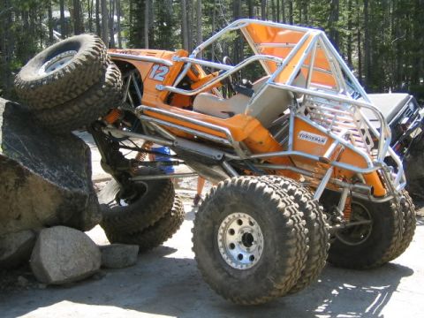 1989 Ford Bronco - Custom off-road buggy navigates a challenging rocky terrain.