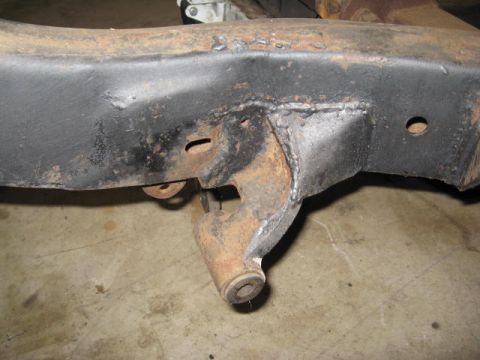 1963 Ford Galaxie - Close-up of a heavily rusted vehicle frame section, showing signs of wear and repair.