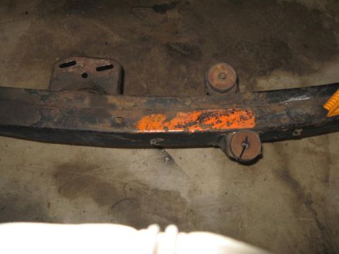 1963 Ford Galaxie - A close-up view of a rusty metal frame component, possibly from a vehicle restoration project, with an orange painted section and the Super…