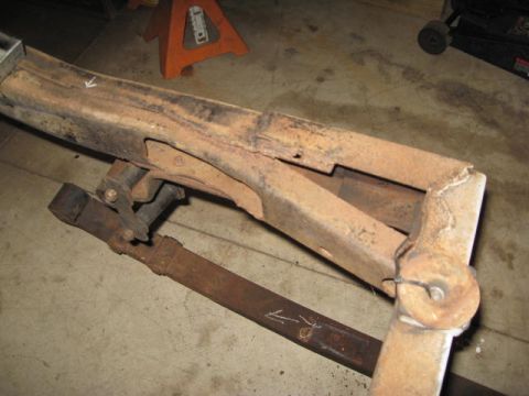 1963 Ford Galaxie - A heavily rusted vehicle frame component is shown, with some suspension parts still attached.