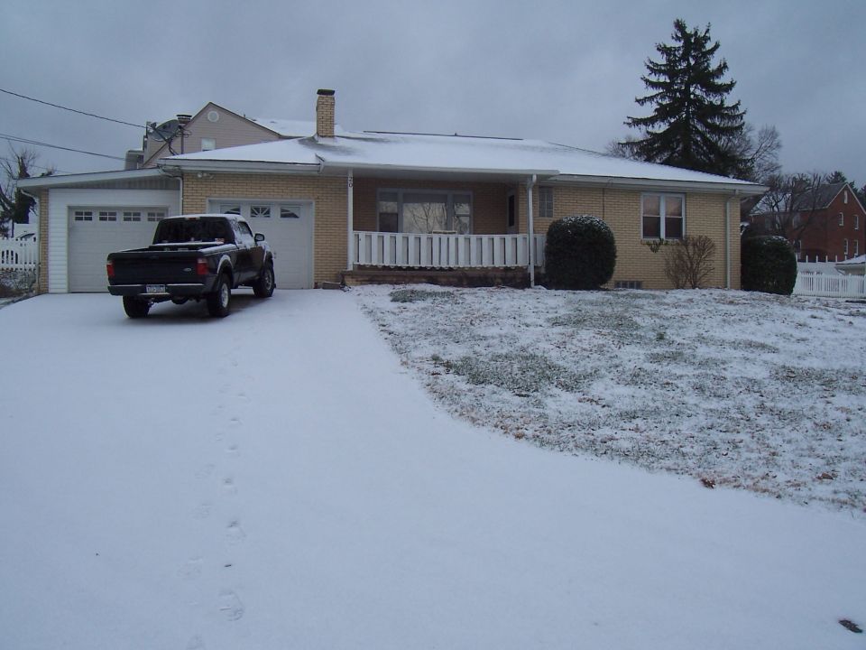 Black pickup truck parked in snowy driveway