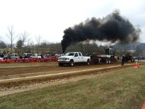 2007 Ford Mustang - White Ford pickup truck competes in a pull, emitting a large cloud of black smoke.