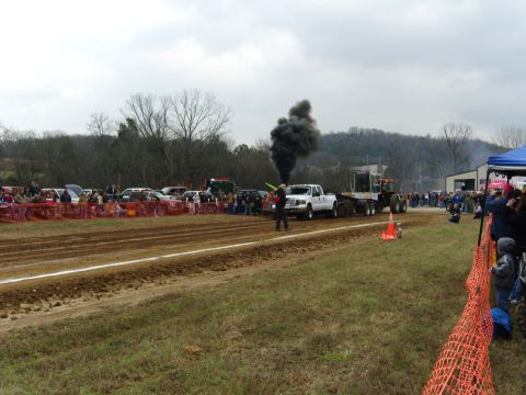 2007 Ford Mustang - A truck participates in a pull event, emitting a large cloud of black smoke.