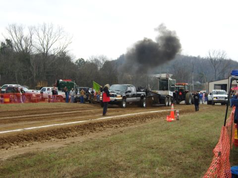 2007 Ford Mustang - A truck participates in a pull event, emitting a large cloud of black smoke.