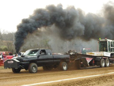 2007 Ford Mustang - A diesel truck emits thick black smoke as it pulls a sled during a competition.