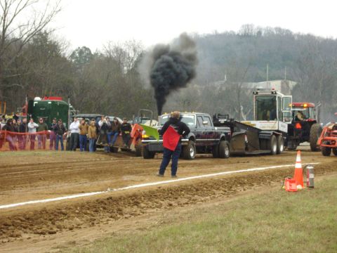 2007 Ford Mustang - A truck competes in a pull event, with spectators watching from the side.