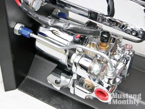 1990 Ford Bronco - Chrome brake booster assembly with blue fittings and black wiring.