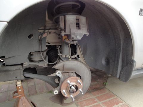 2003 Ford Taurus - Front wheel hub and brake assembly of a 2003 Ford Taurus, showing the suspension and brake components.