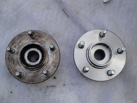 2003 Ford Taurus - A comparison of a used wheel hub assembly next to a new one.