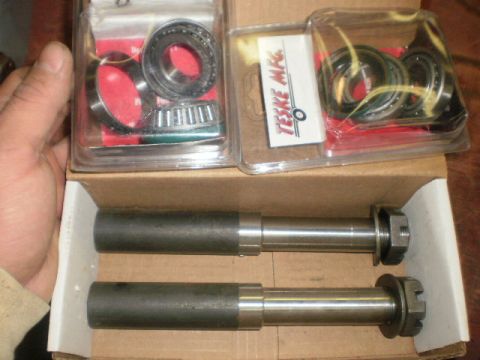 1995 Ford Bronco - Vehicle parts, including bearings and shafts, are laid out in a box and packaging.