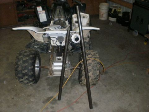 1995 Ford Bronco - Rear view of an ATV with two metal pipes positioned in front of the exhaust.