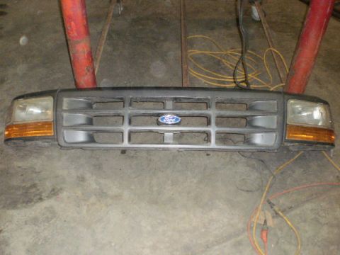 1995 Ford Bronco - This is a front-end grille assembly with headlights, likely from a Ford truck or SUV.