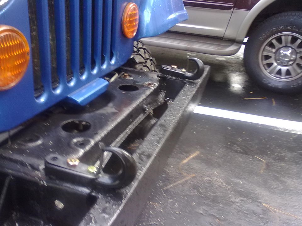 Blue Jeep CJ-series front bumper with tow hooks and grille. 1978 Jeep CJ5