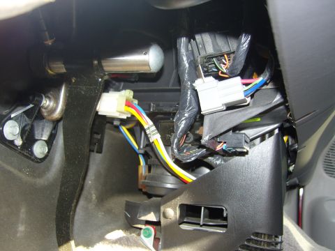 2007 Ford Mustang - Close-up view of the interior wiring harness and connectors located under the dashboard.