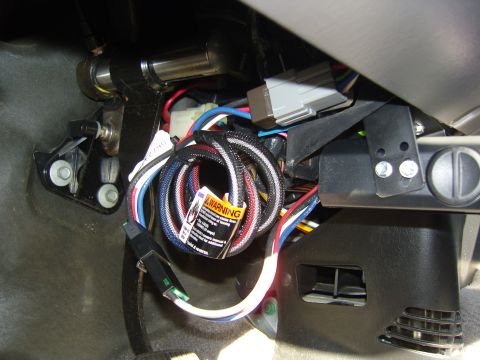 2007 Ford Mustang - Close-up of the wiring harness and installation components for a trailer brake controller.