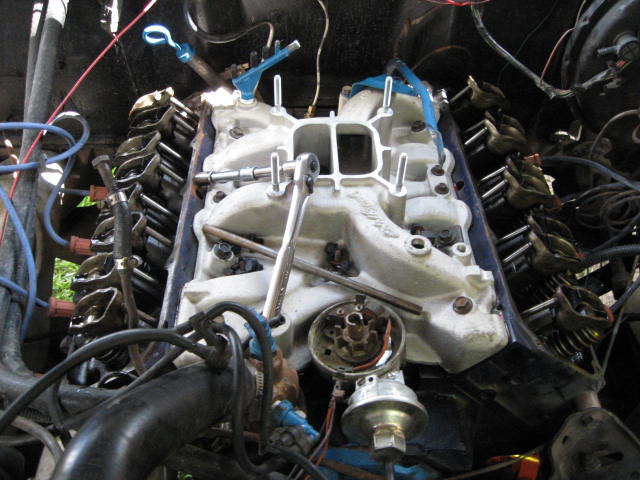 Installing the new intake carb and valve covers.