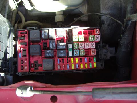 2007 Ford Mustang - Close-up of a car's fuse box, showing multiple relays and fuses.