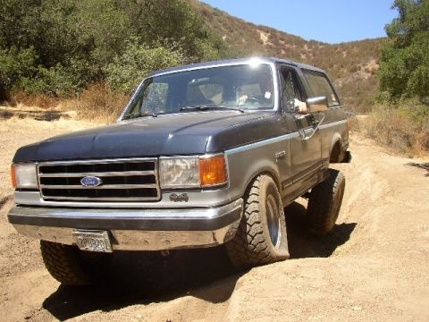 1989 Ford Bronco - This 1987 Ford Bronco navigates a dusty trail, its off-road capabilities.
