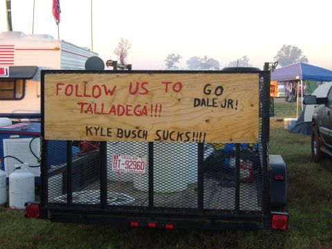 2007 Ford Mustang - A trailer displays a sign supporting Dale Jr. and disparaging Kyle Busch, likely at a racing event.