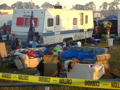 2007 Ford Mustang - A chaotic campsite scene unfolds with a trailer, scattered furniture, and caution tape cordoning off the area.