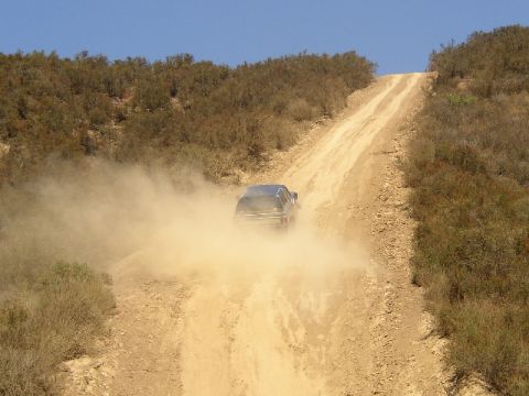 1989 Ford Bronco - 1989 Ford Bronco kicks up dust on a challenging off-road climb.