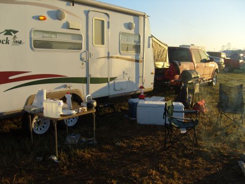 2007 Ford Mustang - Campsite scene with an orange pickup truck and RV, outdoor furniture and a grill.