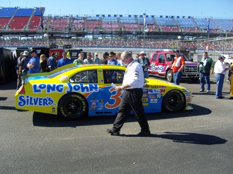 2007 Ford Mustang - A NASCAR race car, identified as a 2007 Ford Mustang, is seen on the track with its sponsors displayed.