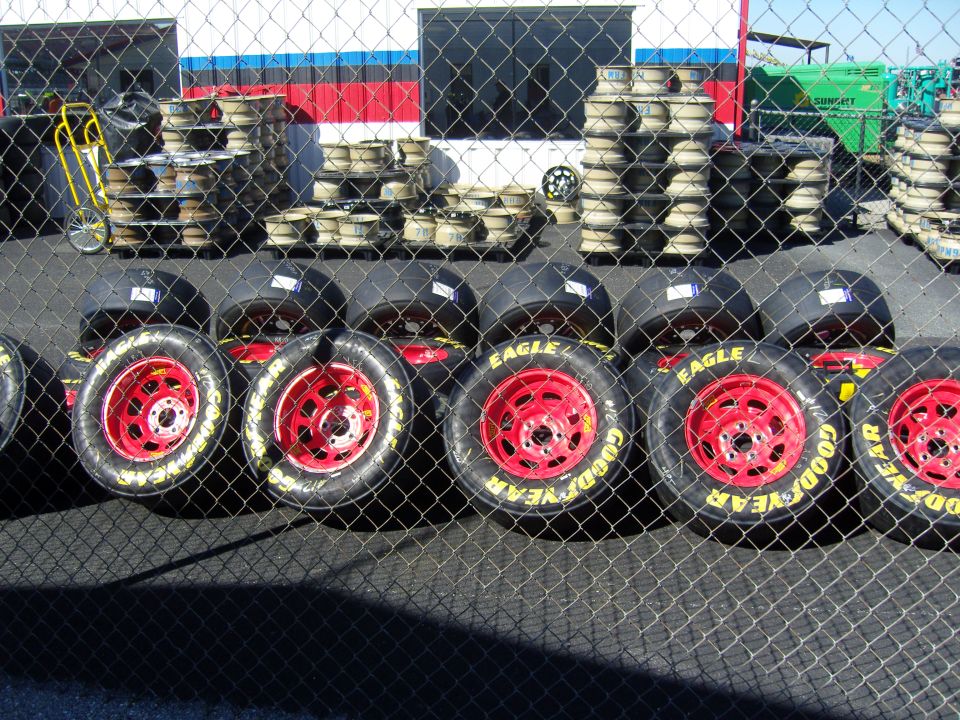 Race car tires with red wheels and Goodyear Eagle branding