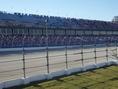 2007 Ford Mustang - A view of a racetrack and its seating area under a clear blue sky.