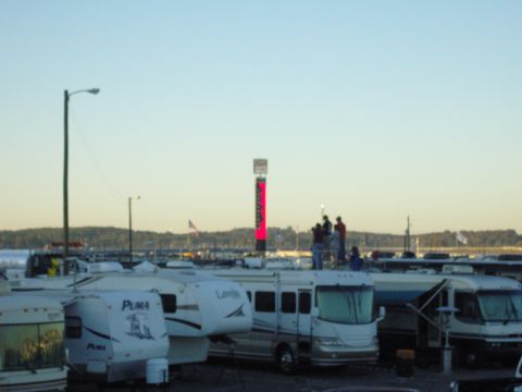 2007 Ford Mustang - An RV park scene with a tall digital scoreboard displaying red lights, and several recreational vehicles parked.