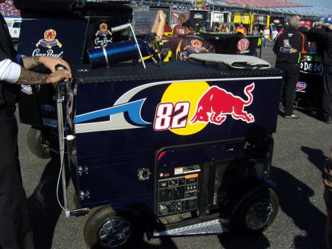 2007 Ford Mustang - A generator unit with Red Bull branding and the number 82 is visible at a race track.