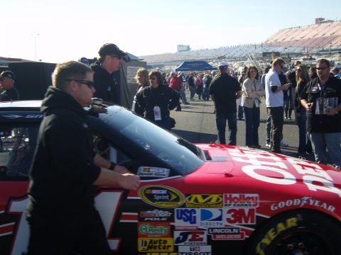 2007 Ford Mustang - Race car with sponsor decals at a NASCAR event. The specific model year is not discernible from the image.