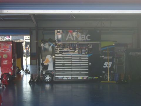 2007 Ford Mustang - A garage scene with various tool chests and racing equipment, including a prominent duck decal.