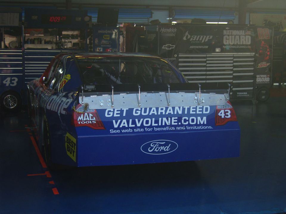 Race car with Valvoline.com on the spoiler and Ford logo on the rear bumper. Car number 43 is visible