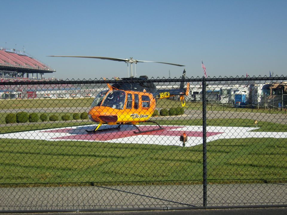 Orange and black helicopter on a helipad with "Life Flight" text