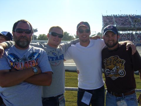 2007 Ford Mustang - Four friends are pictured together at a sporting event, with spectators visible in the stands behind them.
