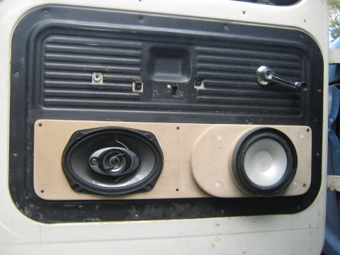1972 Ford F-250 - Aftermarket speakers are mounted onto a wooden panel on a white truck's interior door.