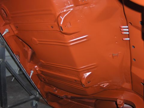 1972 Chevrolet Camaro - Orange painted car undercarriage with visible structural supports and mounting hardware.