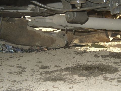 1989 Ford Bronco - The exhaust system appears to be significantly damaged, with rust and debris visible.