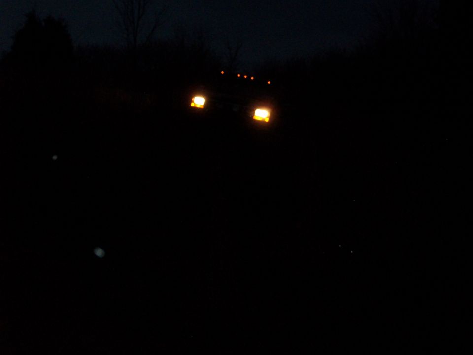 1995 Ford Bronco front view at night, headlights on