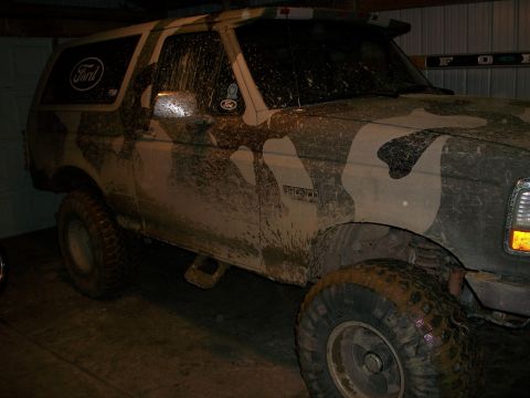 1995 Ford Bronco - This 1995 Ford Bronco is covered in mud and has a camouflage paint job.