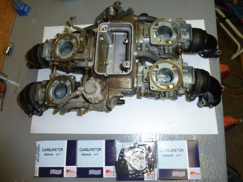 1978 Honda GL1000 - A set of four carburetors is laid out with carburetor repair kits underneath.
