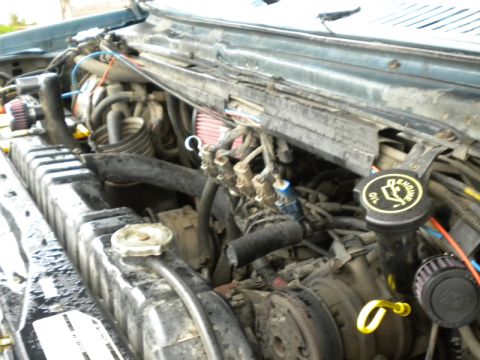 1989 Ford Bronco - Close-up view of a vehicle's engine compartment, showing various mechanical components and wiring.