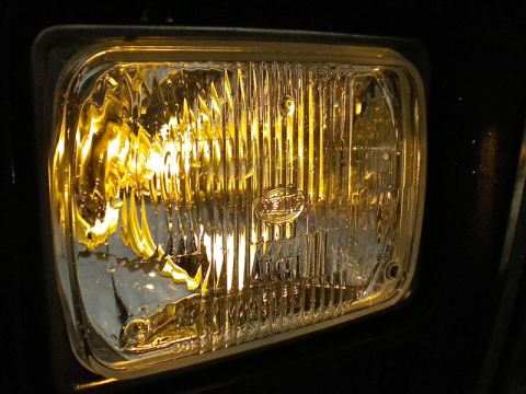 1989 Ford Bronco - This close-up shows a yellow headlight with Hella branding, a component that could be found on various vehicles.