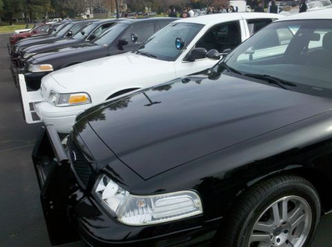 2004 Ford Crown Victoria - Several Ford Crown Victoria police interceptors are parked in a row, ready for duty.